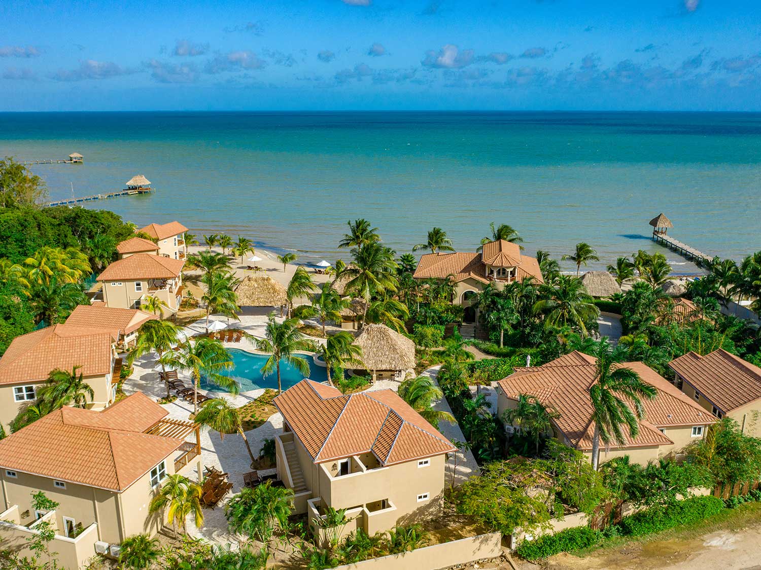 An aerial view of an island beach resort and villa.