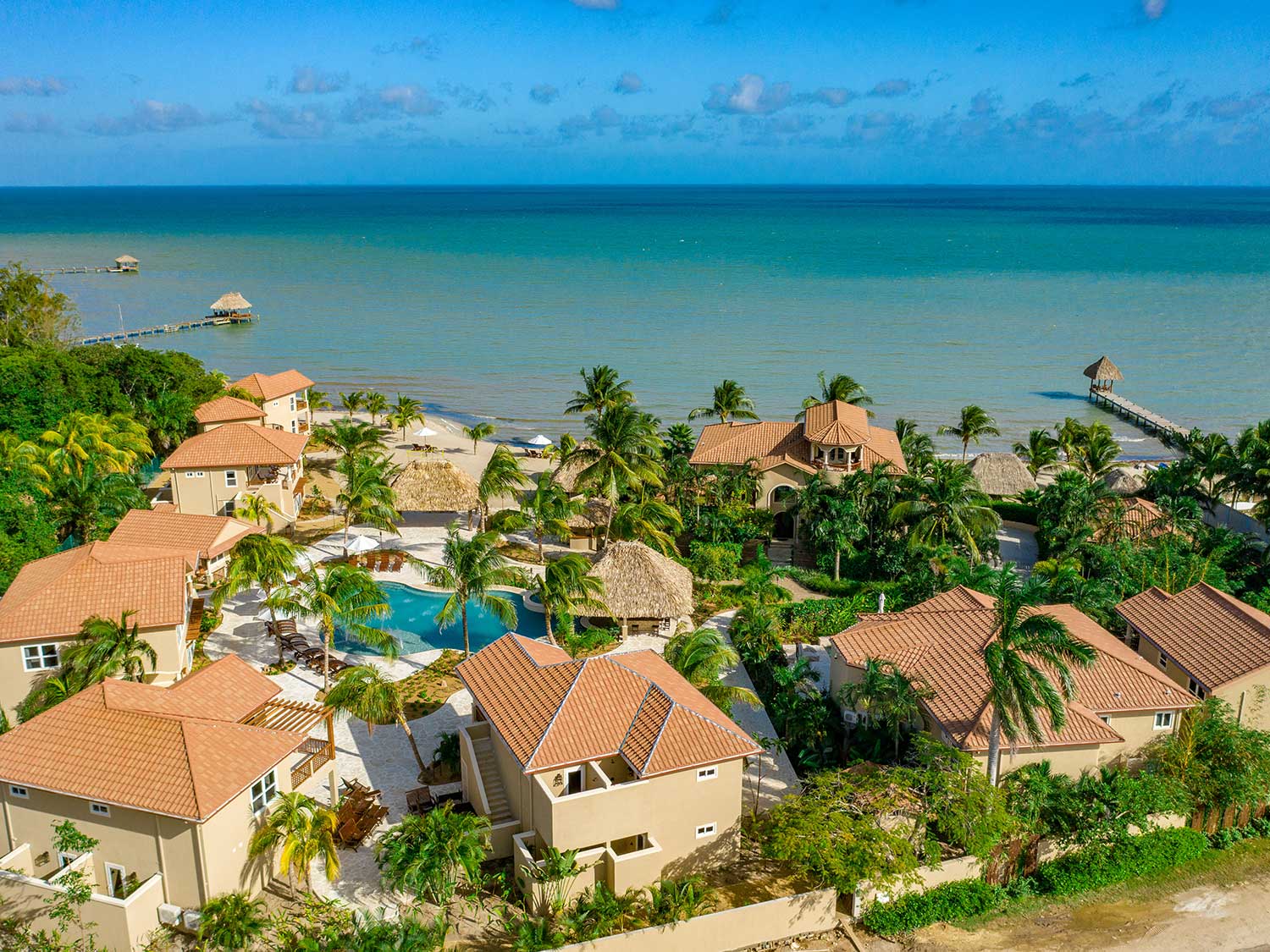 An aerial view of an island beach resort and villa.