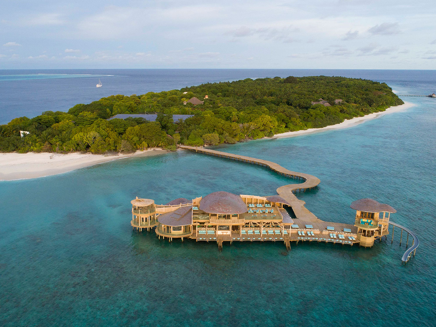 A resort and pier attached to a small island.