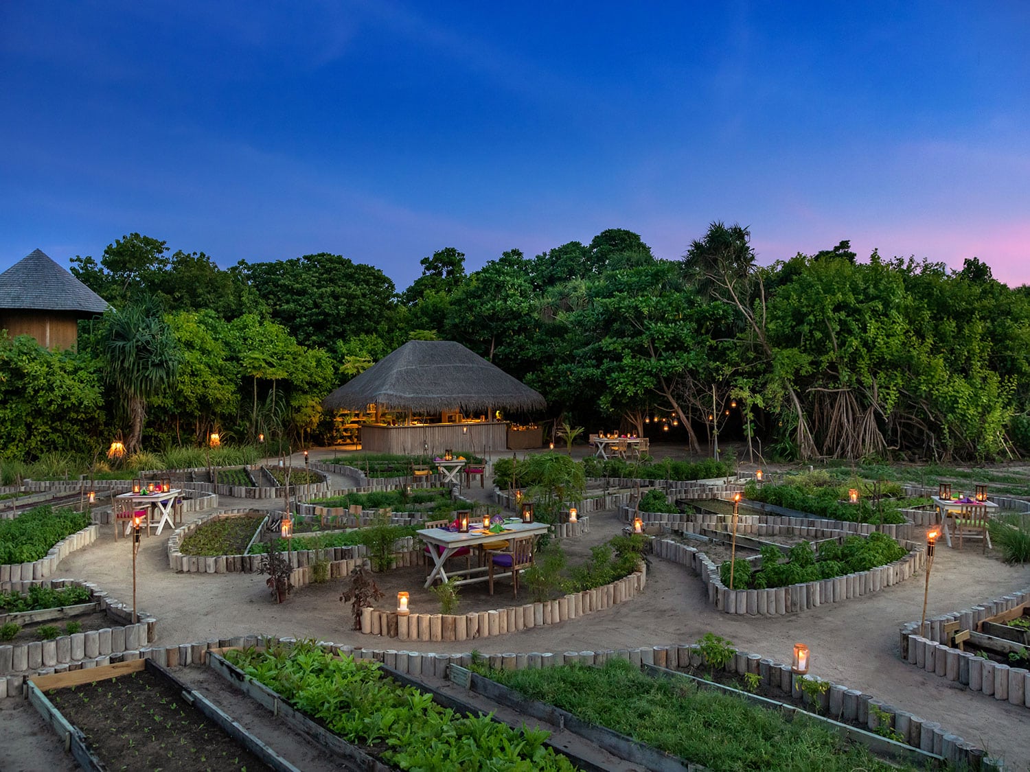 An island resort lit up by lanterns at night.