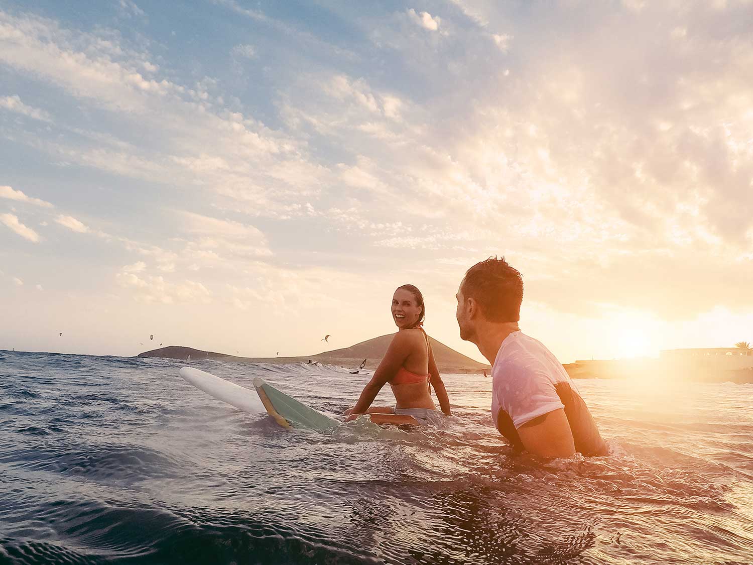 people sitting on surfboards in the ocean