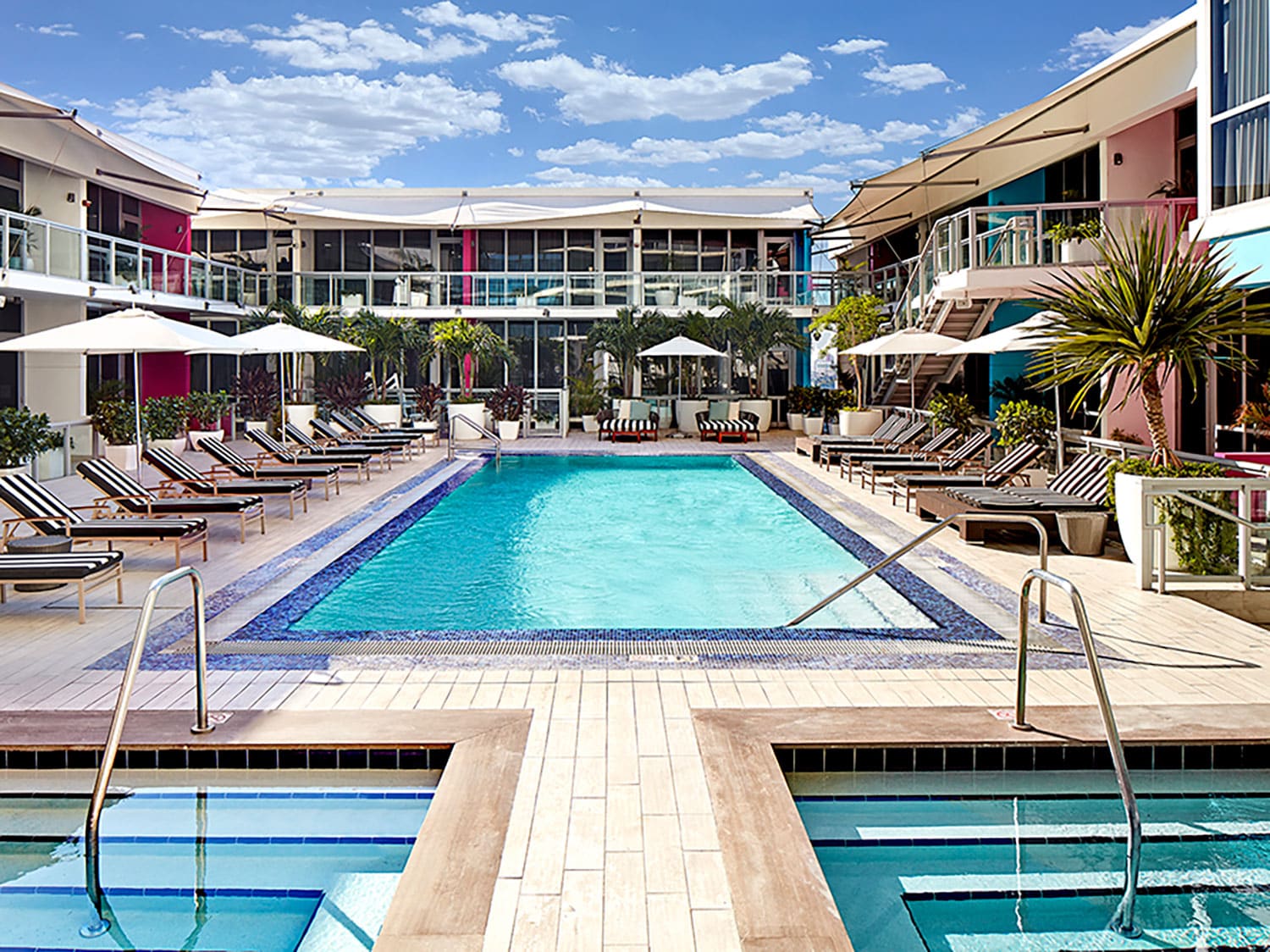A resort style lounge pool surrounded by buildings at The Gabriel Miami.