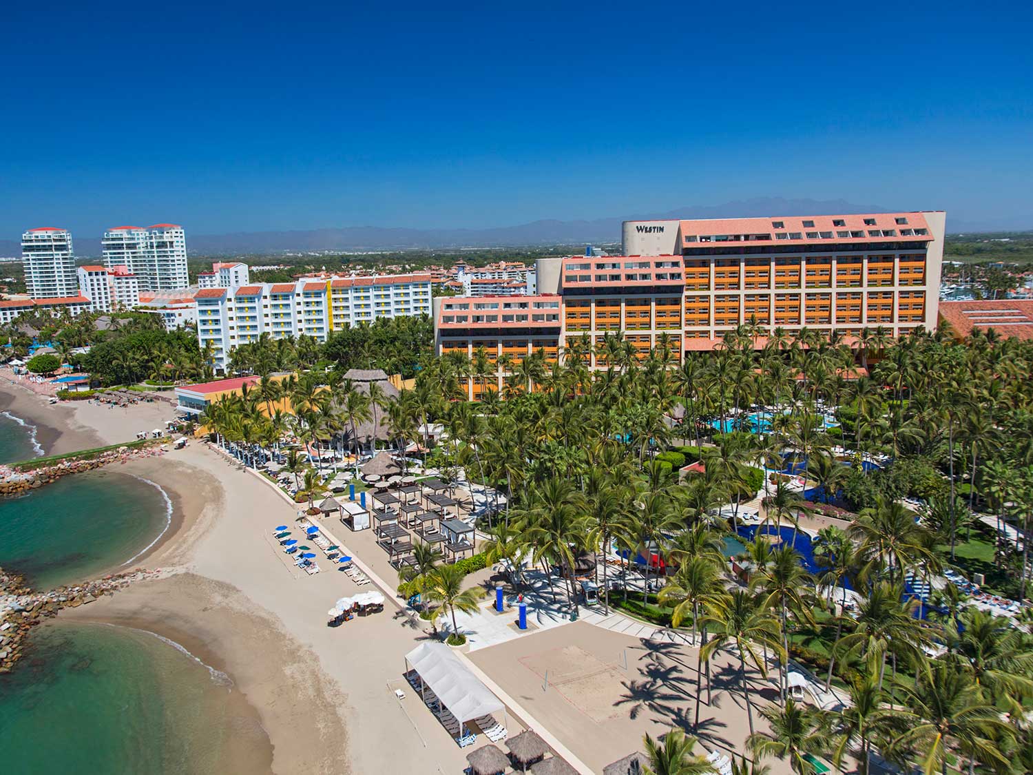 An aerial view of an island beach resort.