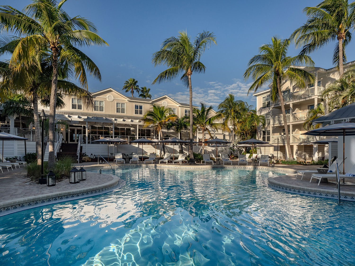 The exterior spa style pool at the Margaritaville Beach House. The pool is surrounded by palm trees.