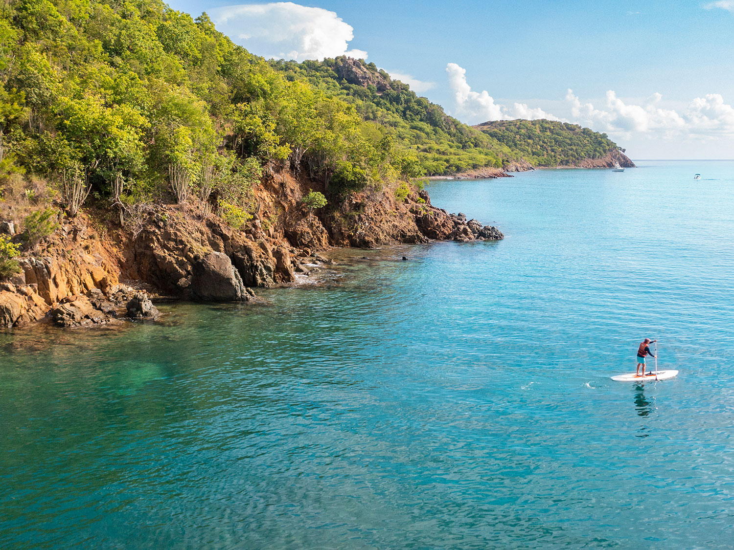 A person paddleboarding off Carlisle Bay in Antigua.