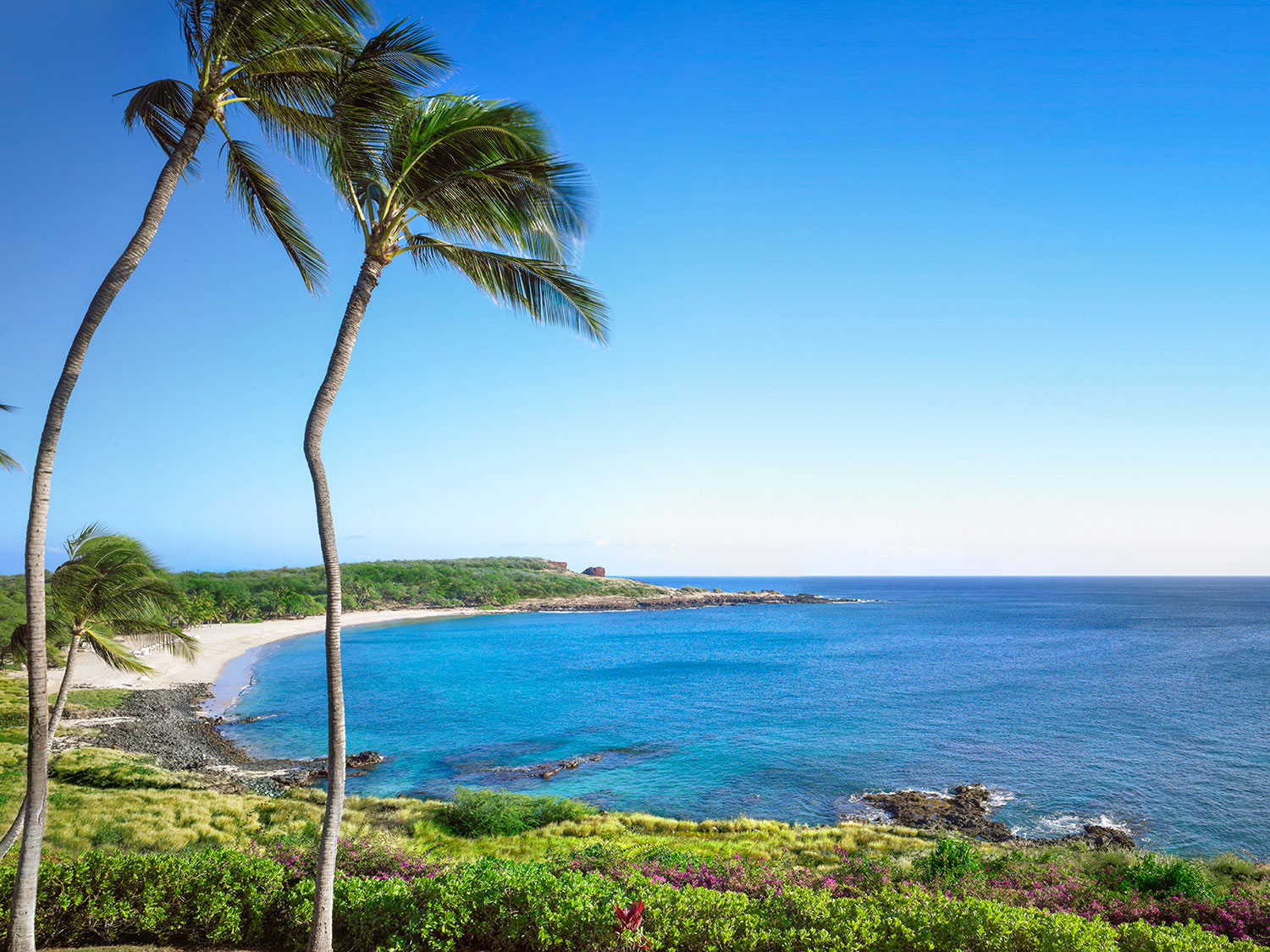 The beach and ocean shore of the Four Seasons Lanai.