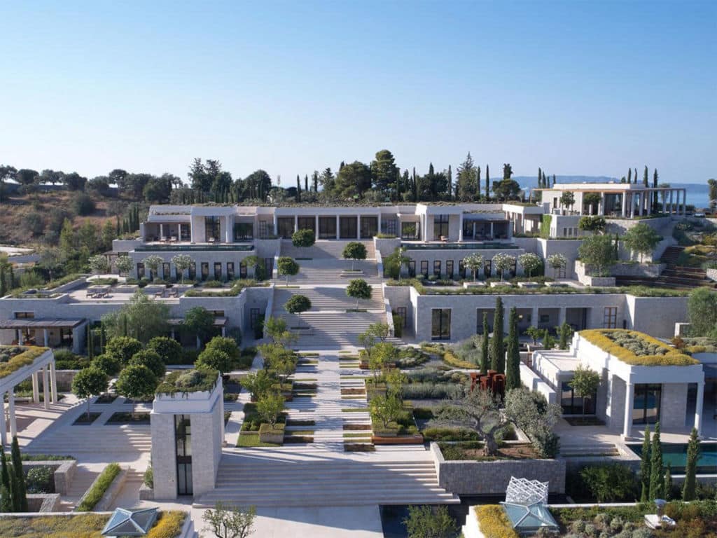 An aerial view of Amanzoe's Villa 20 multilevel property and pools.