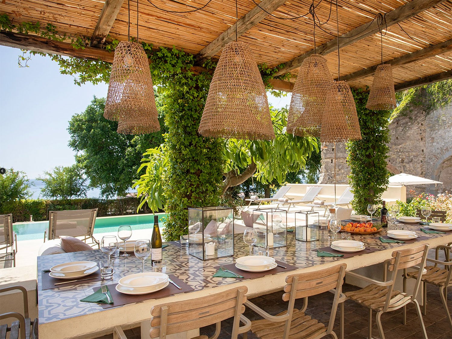 The outdoor, poolside dining area at La Prora, a seven-bedroom luxury villa in Taormina, Sicily, Italy.