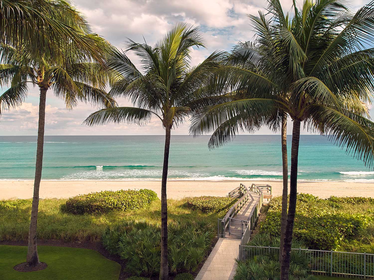 Wooden walkway access to The Boca Raton’s private beach