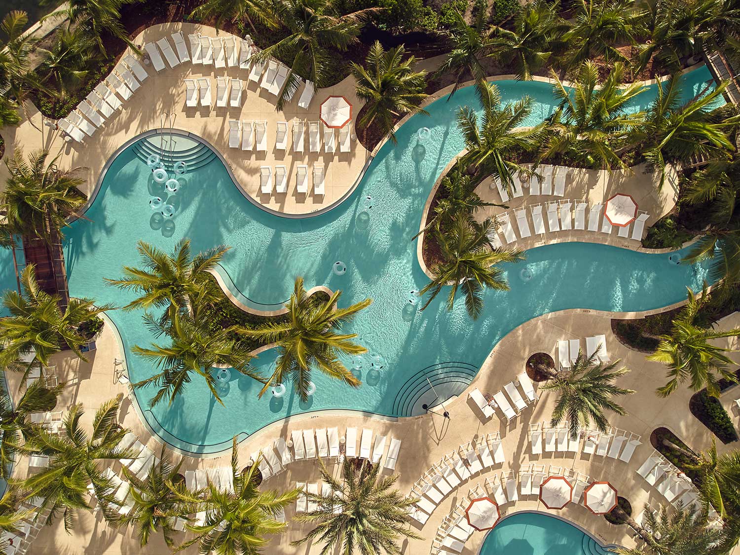 Aerial view of the palm tree flanked lazy river at The Boca Raton in southern Florida