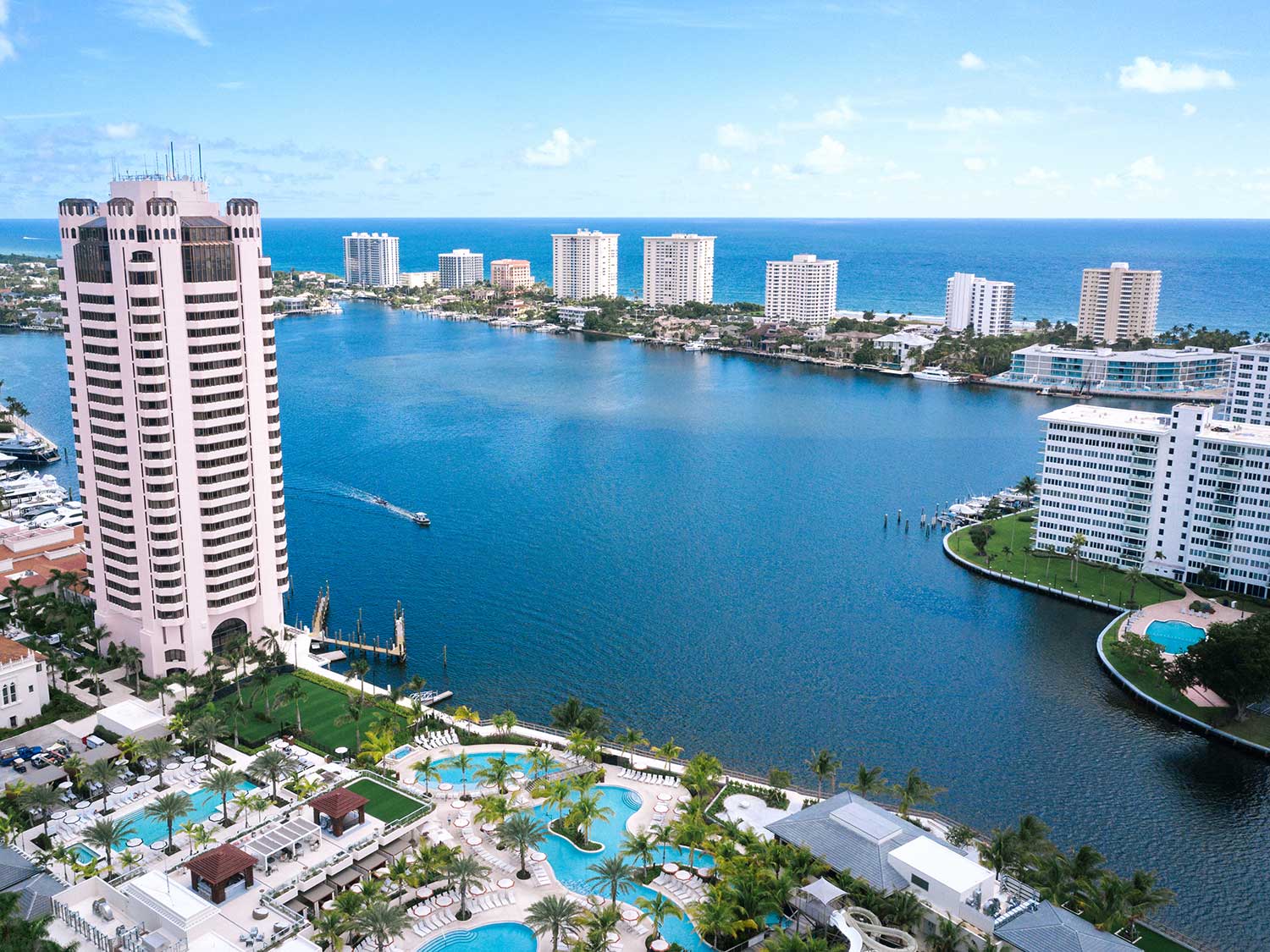 Aerial view of the light pink Boca Raton Tower and harbor