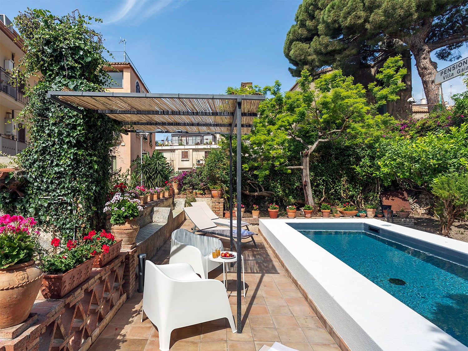 The pool and outdoor space at the three-bedroom Villa Carmine in Taormina, Sicily, Italy.