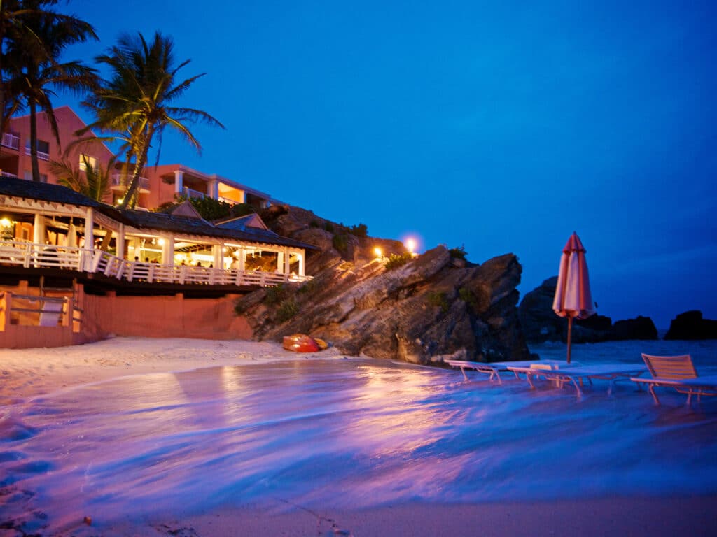 A nighttime view of the exterior and beach at The Reefs Resort and Club in Bermuda.
