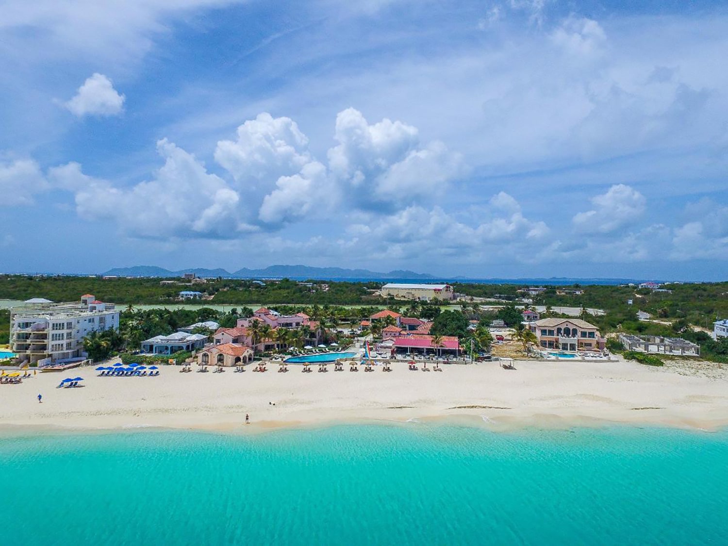 An exterior view of the property and beach at Frangipani Beach Resort in Anguilla.