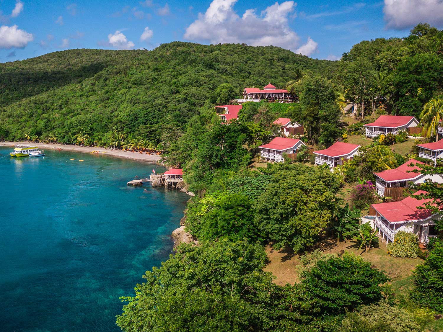 An aerial daytime view of the beach and property at Ti Kaye Resort and Spa in St. Lucia.