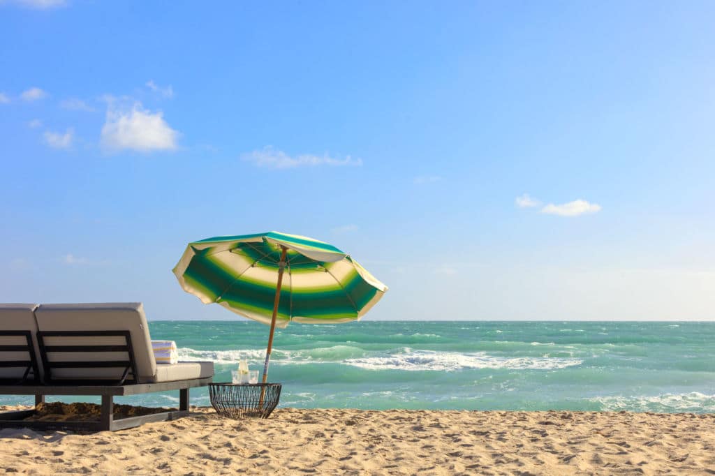 A two-person lounger on the beach at Kimpton Surfcomber Hotel in Miami Beach, Florida.
