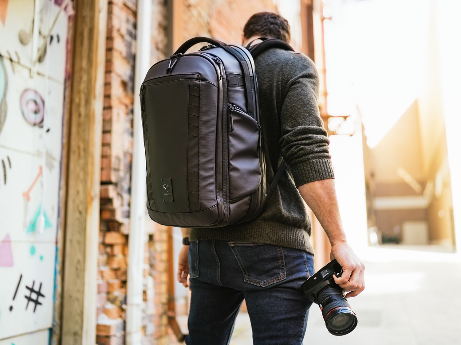 A photographer wearing the Nomatic McKinnon Camera Pack 35L.