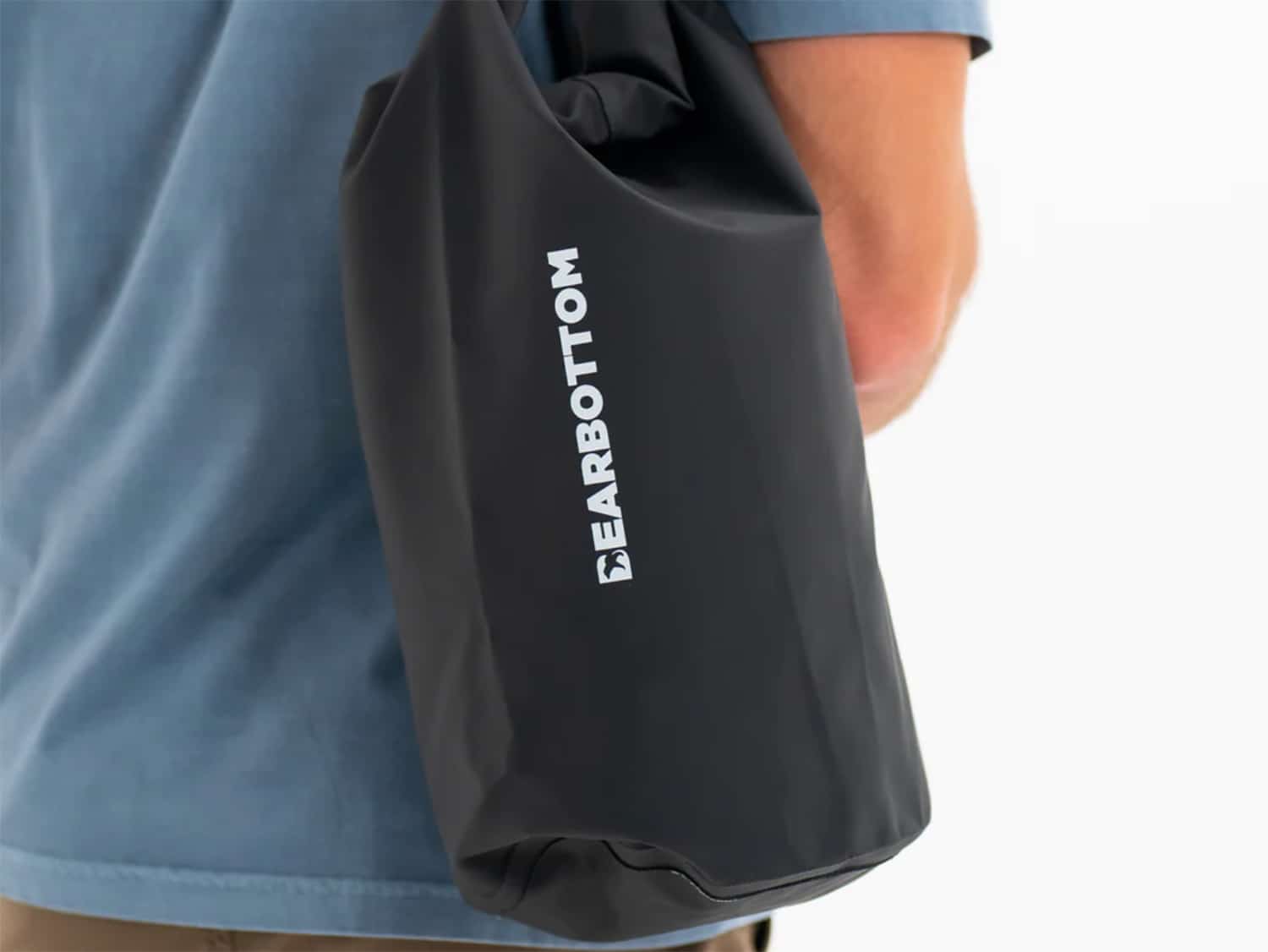 A man carrying the Bearbottom Rapids Dry Bag 10L.