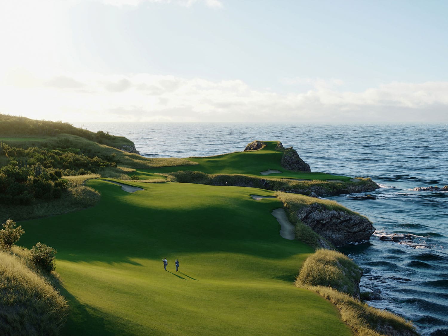 An aerial view of two golfers playing a hole at Point Hardy Golf Club on the Caribbean island of Saint Lucia.