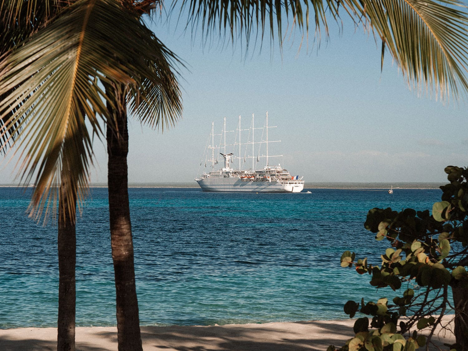 A view of the Club Med 2 luxury sailing yacht from a beach.
