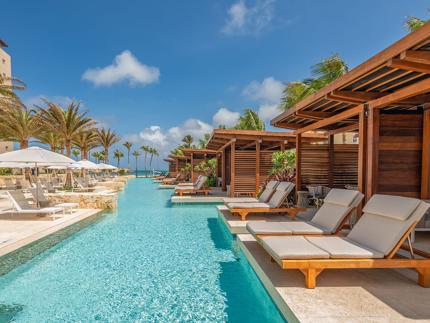 The pool and private cabanas and loungers at Hyatt Regency Aruba Resort Spa and Casino.