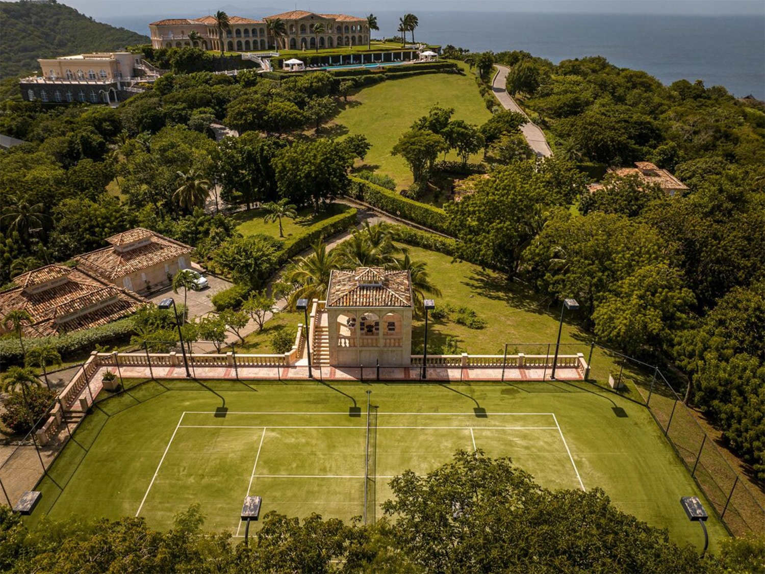 An aerial view of the tennis court and gardens of The Terraces, a $200 million dream home on the Caribbean island of Mustique in St. Vincent and the Grenadines.