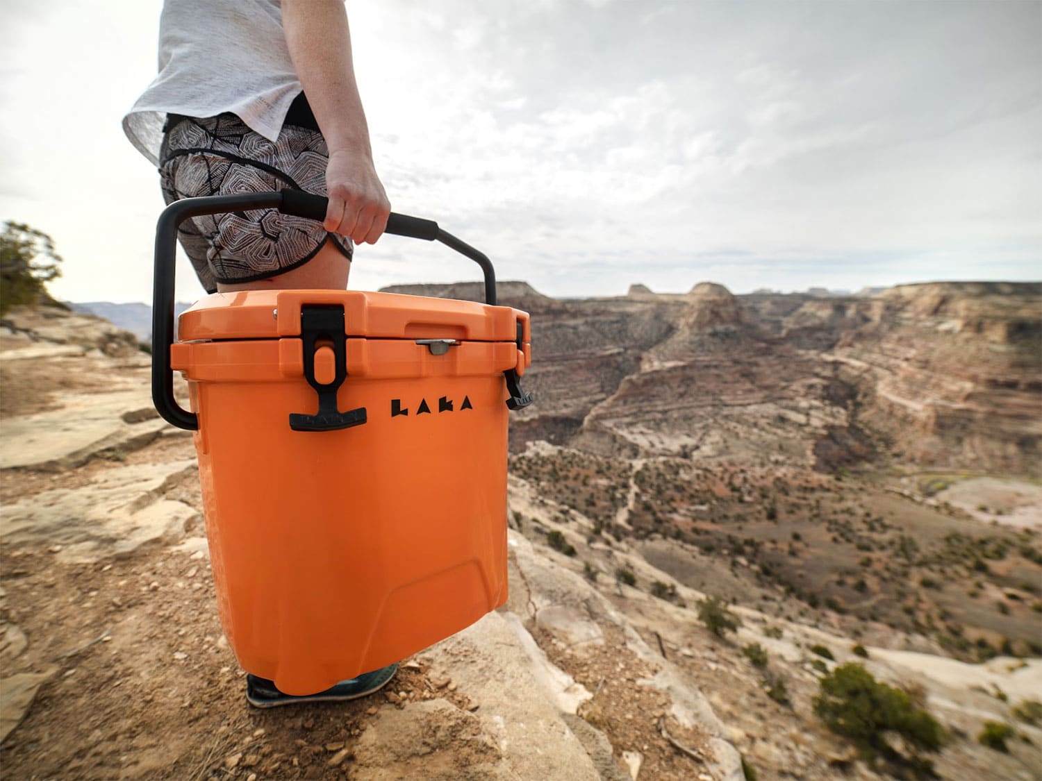 A LAKA Cooler being carried on the beach.