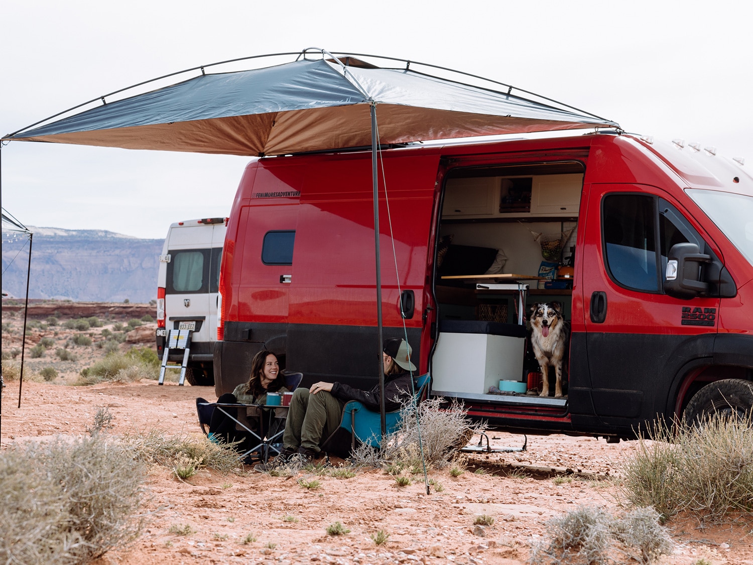 Van campers sitting beneath the MoonShade XL portable awning.