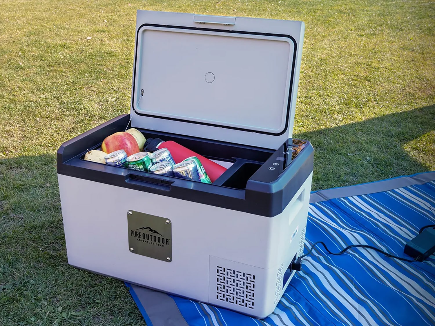 The Pure Outdoor Portable Refrigerator holding various drinks.