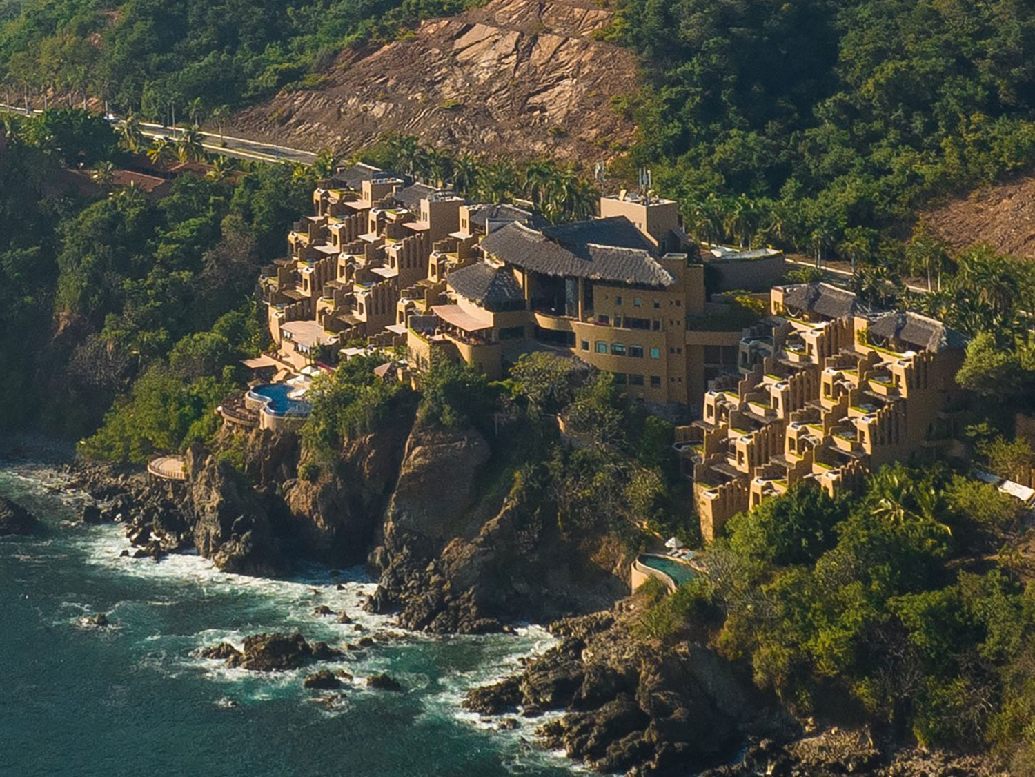 An aerial view of the exterior of the cliffside setting of Cala de Mar Resort and Spa in Mexico.
