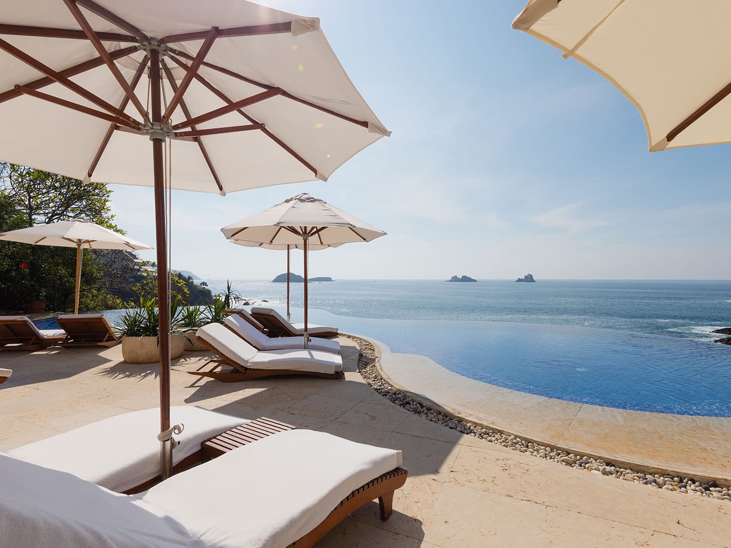 Lounge chairs at the infinity pool at Cala de Mar Resort and Spa in Mexico.