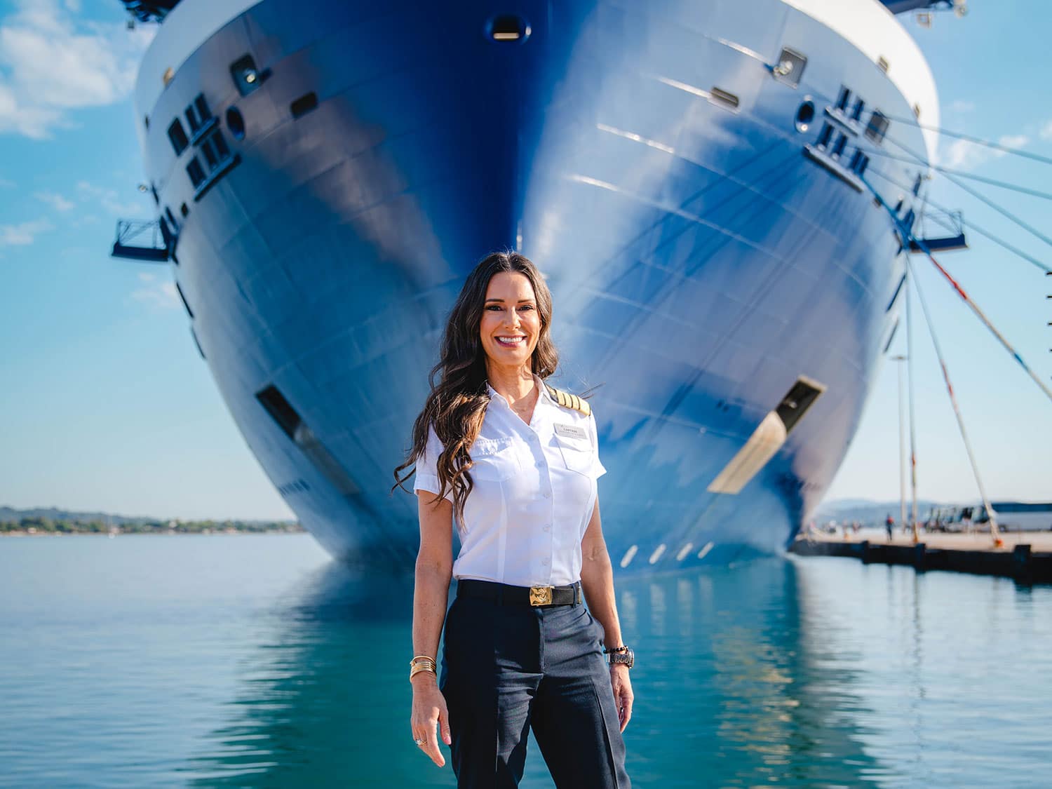 Captain Kate McCue standing in front of her ship, Celebrity Beyond from. Celebrity Cruises.