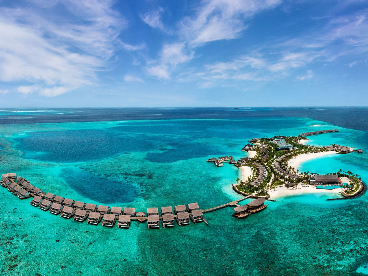 An aerial view of the property and overwater bungalows at Hilton Maldives Amingiri Resort and Spa.