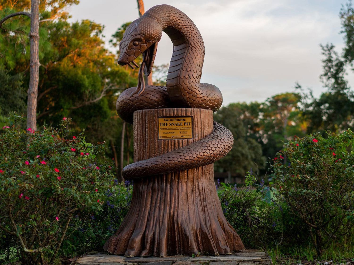A decorative copperhead snake statue welcomes golfers to the 