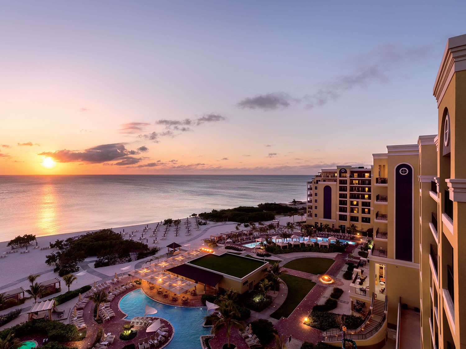 An aerial exterior view of the pool and beach at the Ritz-Carlton Aruba resort in the Caribbean.