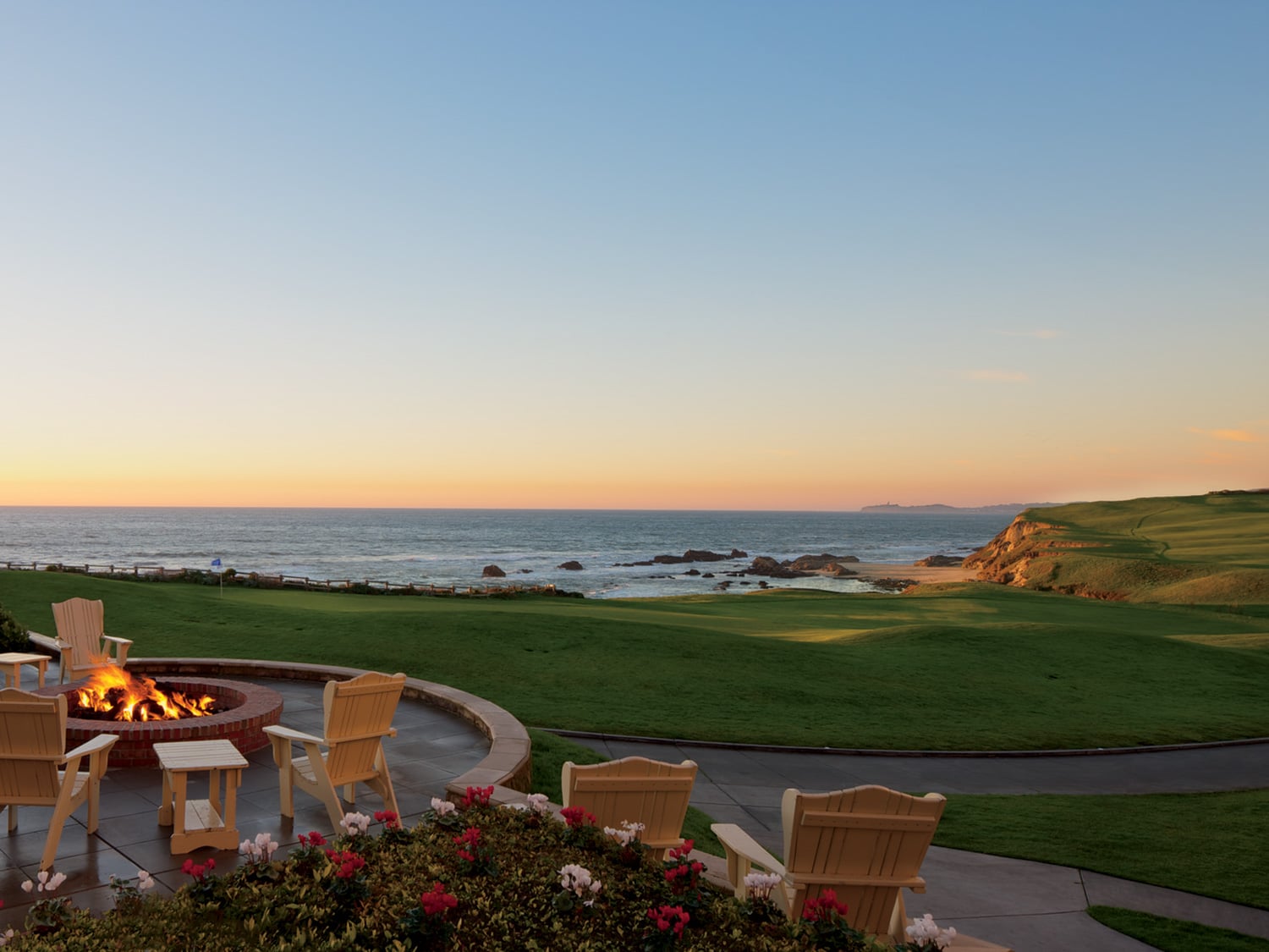 A fire pit view of the sunset from The Ritz-Carlton Half Moon Bay resort in California.