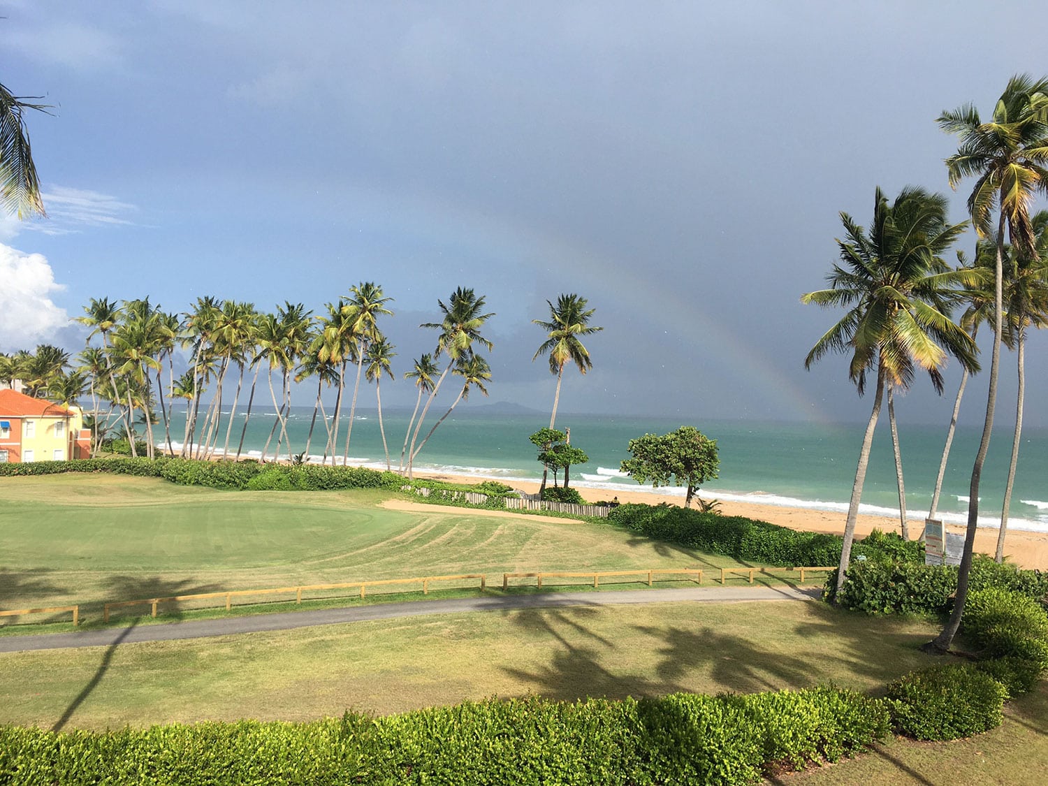 An aerial view of the golf course and beach at Wyndham Palmas Beach and Golf Resort in Puerto Rico.