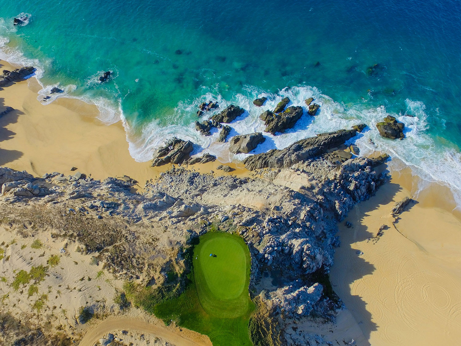 An aerial drone’s eye view of the 14th hole at Quivira Golf Club in Los Cabos.