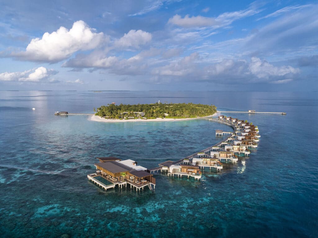 An aerial view of the Overwater Reef Residence and other accommodations at Park Hyatt Maldives Hadahaa.