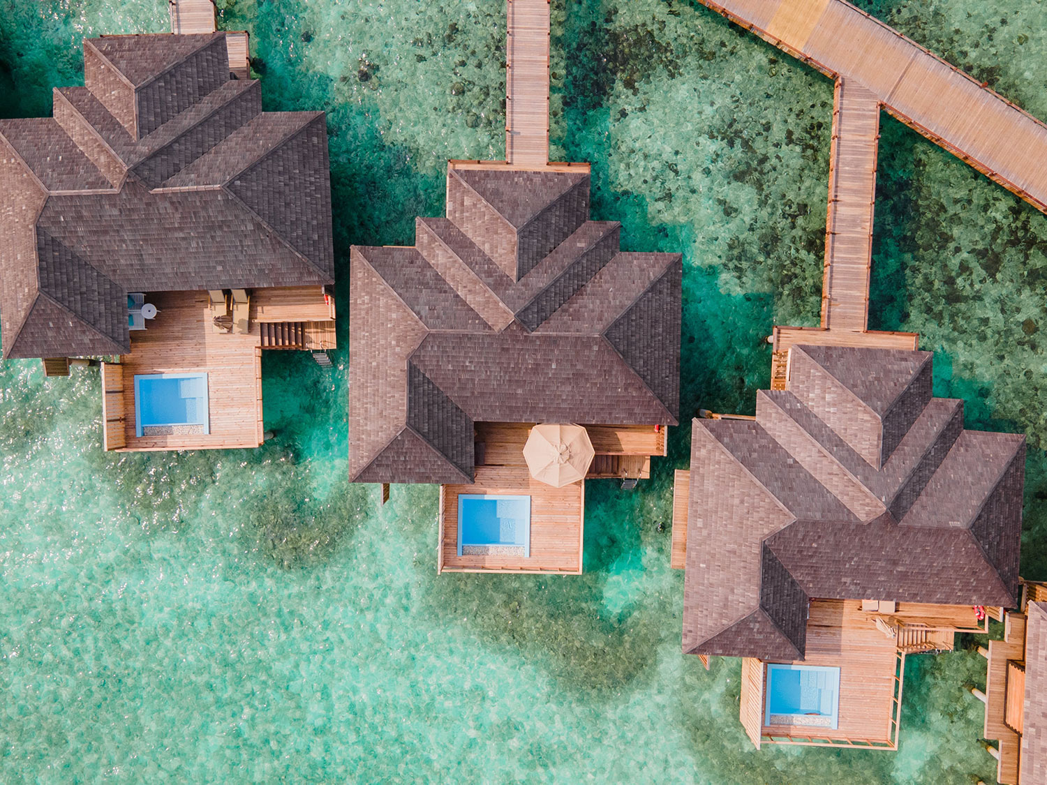 An overhead view of the bungalows at Sun Siyam Ira Fushi in the Maldives